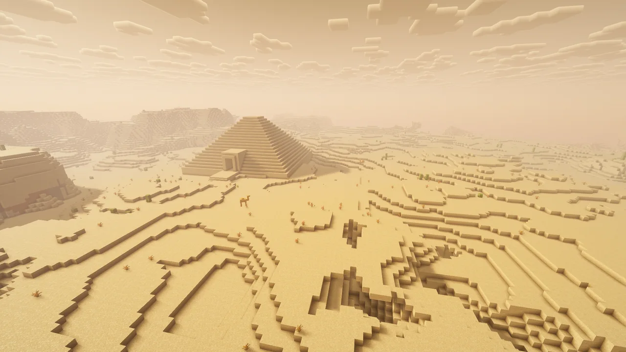 The pyramid seen from a ridge, dunes and rock outcrops around it